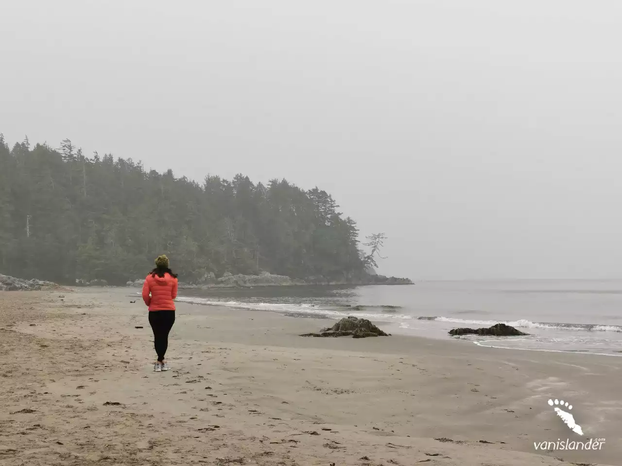 A woman walking along the beach at Tonquin Park,  Vancouver Island